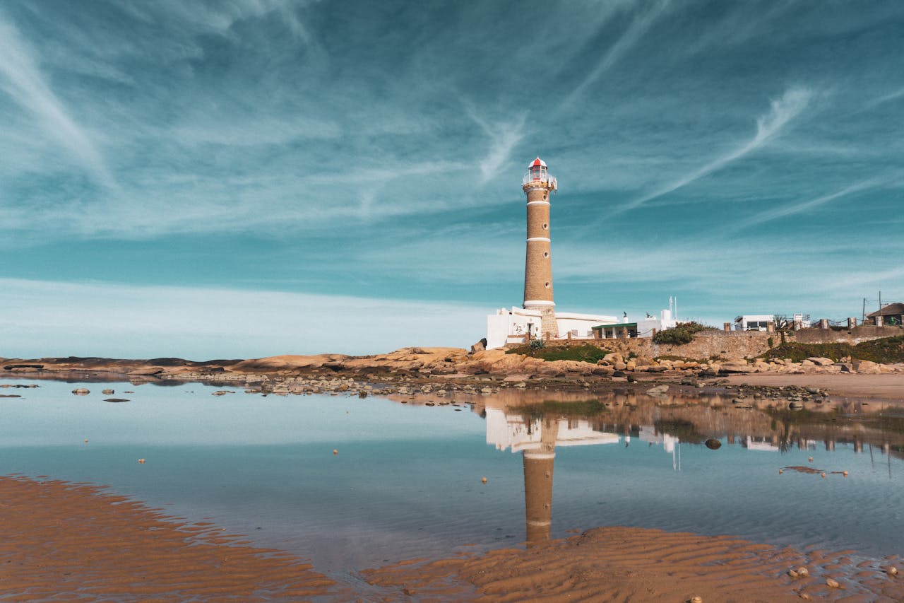 Faro de José Ignacio lighthouse reflected in calm sea waters, Uruguay