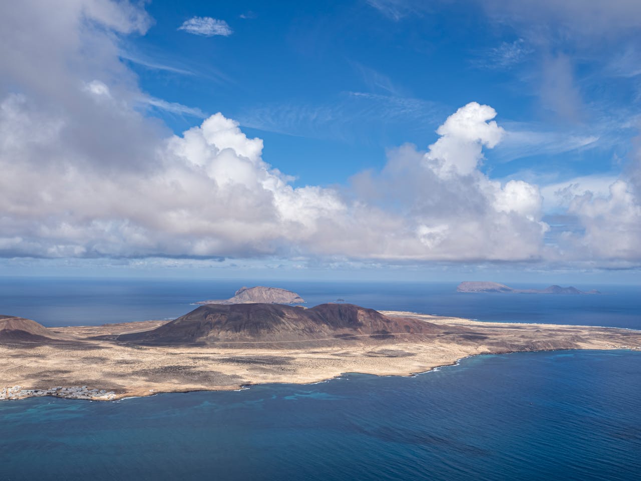 Aerial view of Lanzarote's volcanic landscape meeting the Atlantic Ocean — Canary Islands Biosphere Reserve