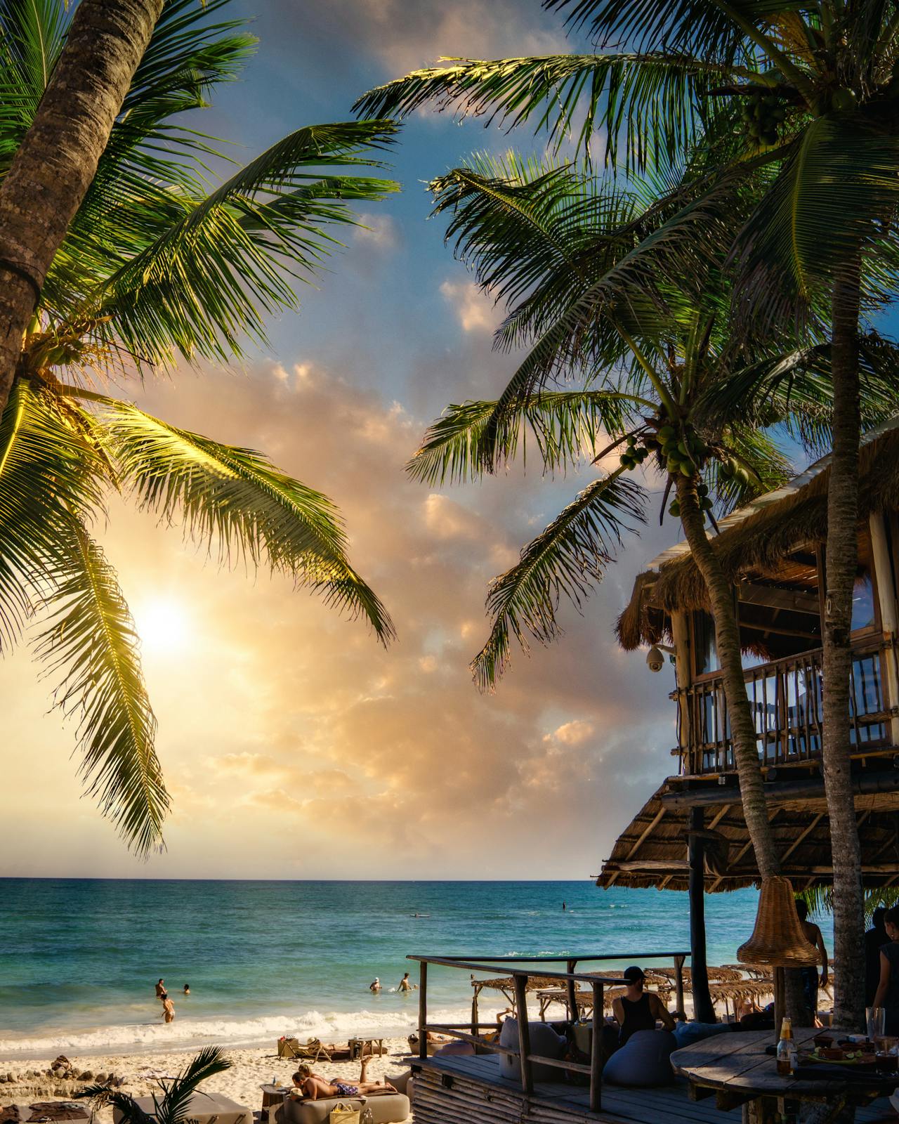 Tulum beach at sunset with coconut palms, Caribbean coast Mexico