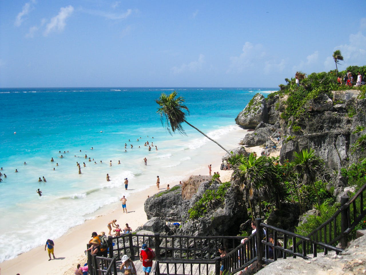 Tulum beach with turquoise water and rocky cliffs, Caribbean Mexico