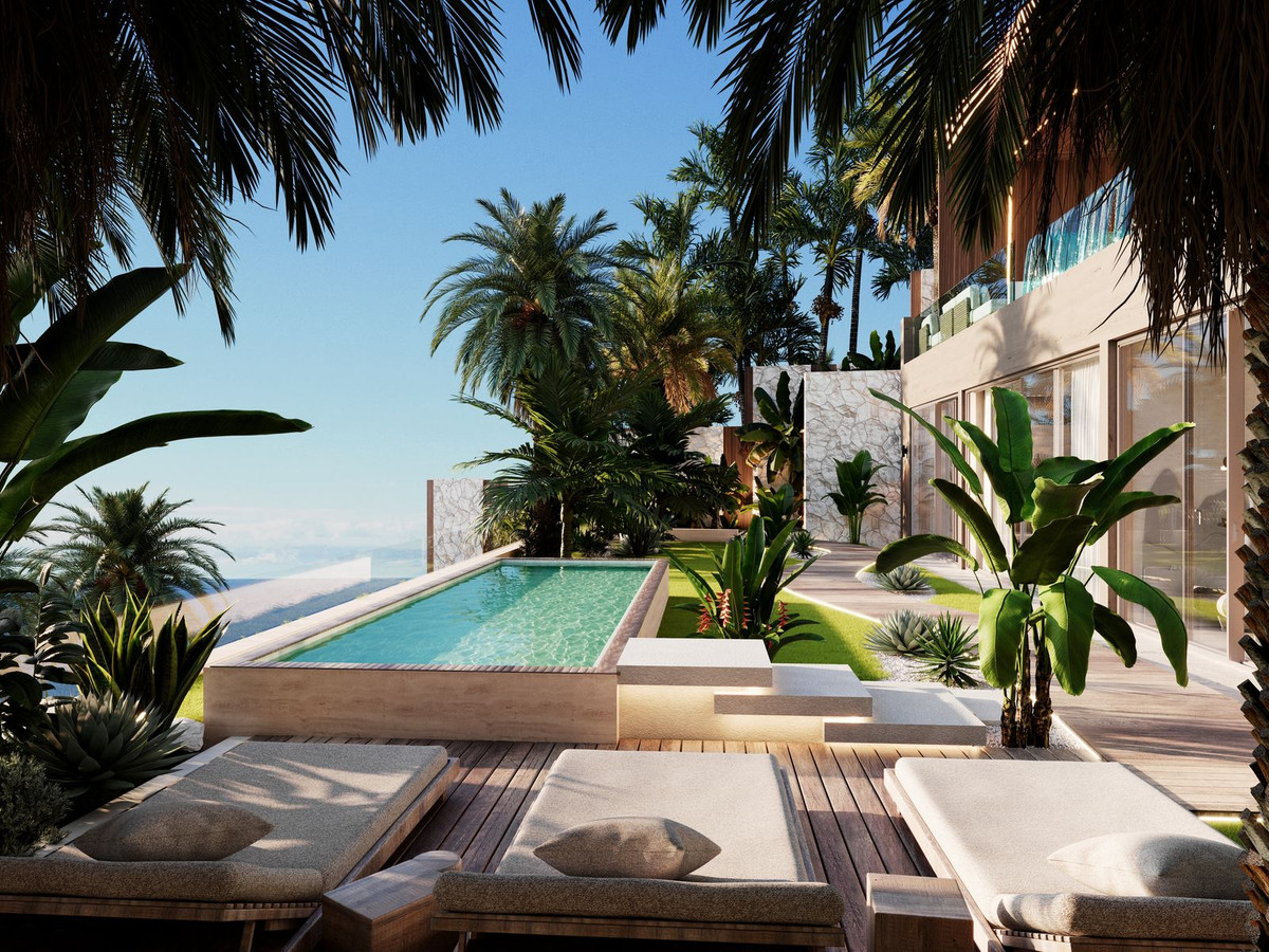 Tropical villa garden with pool and palm trees in morning light — luxury lifestyle Marbella