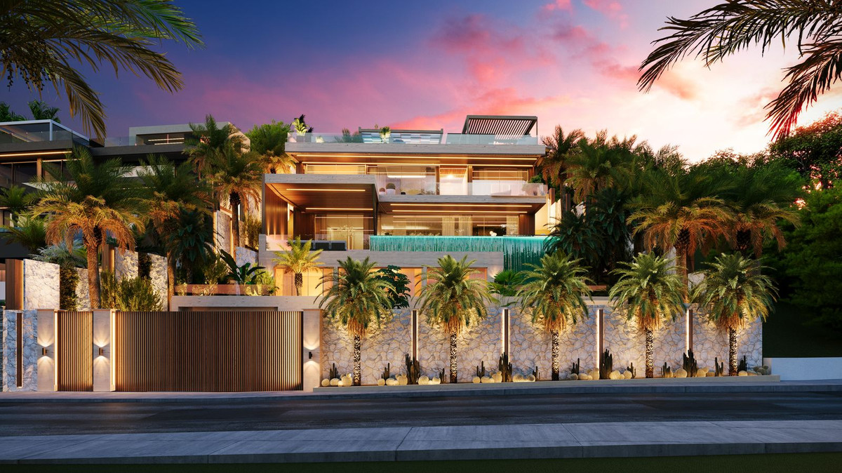 Dramatic luxury villa exterior at sunset with tropical landscaping — architecture Marbella