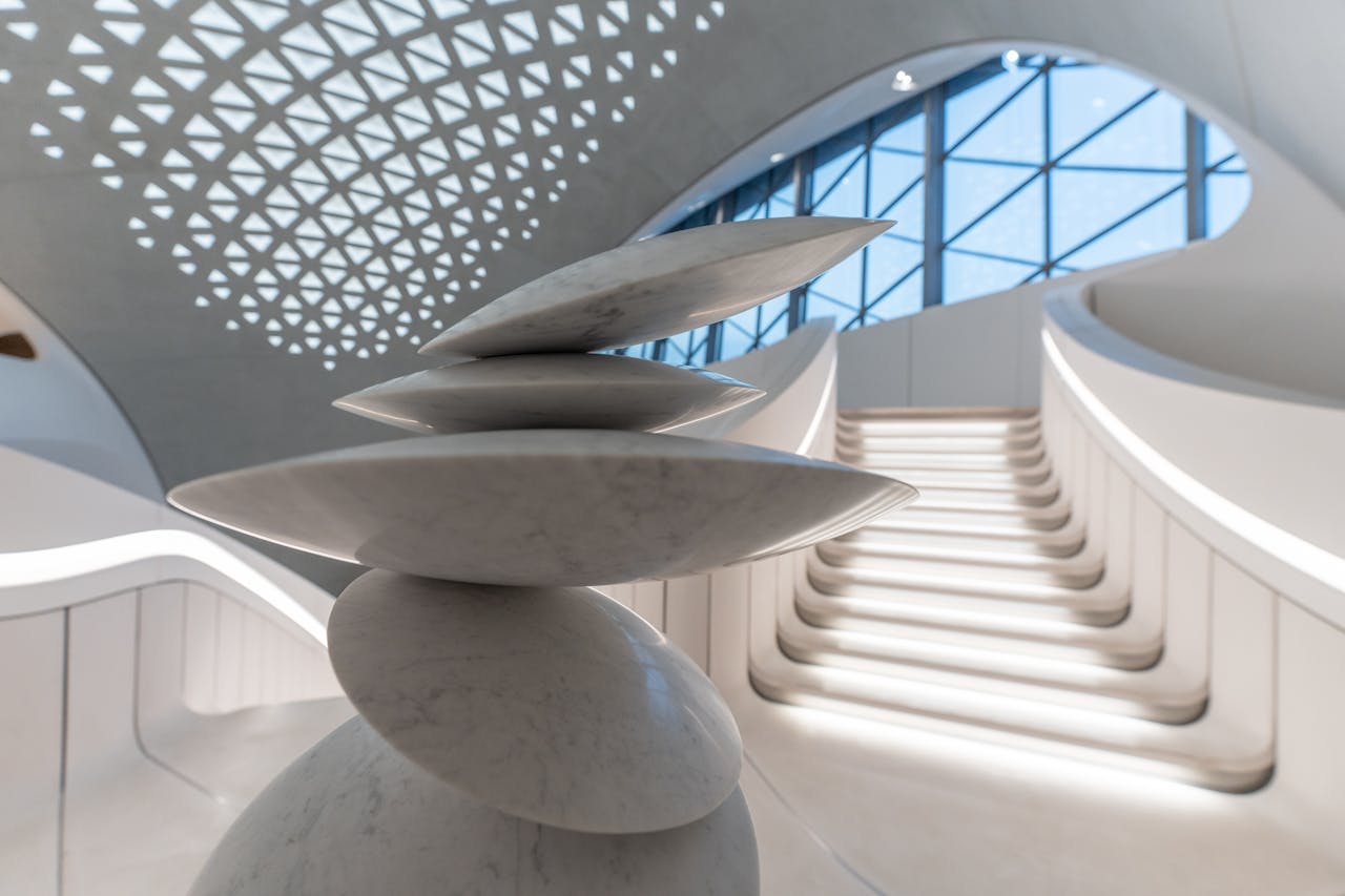 Sculptural floating staircase in minimalist white interior — spatial architecture design authorship